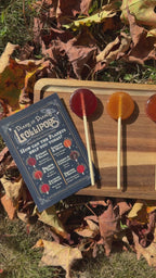 Video scanning the Plants and Planets Lollipops sitting upon a wooden board on a bed of fallen autumn leaves
